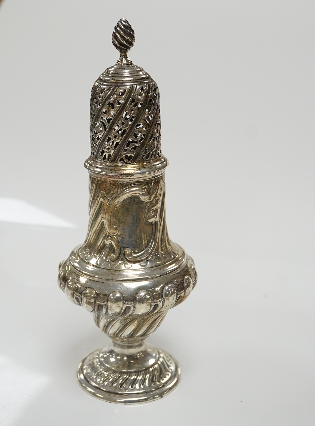 A Victorian repousse spiral fluted pedestal sugar caster, Thomas Bradbury & Sons, London, 1889, 18.3cm, 3.9oz. Condition - fair